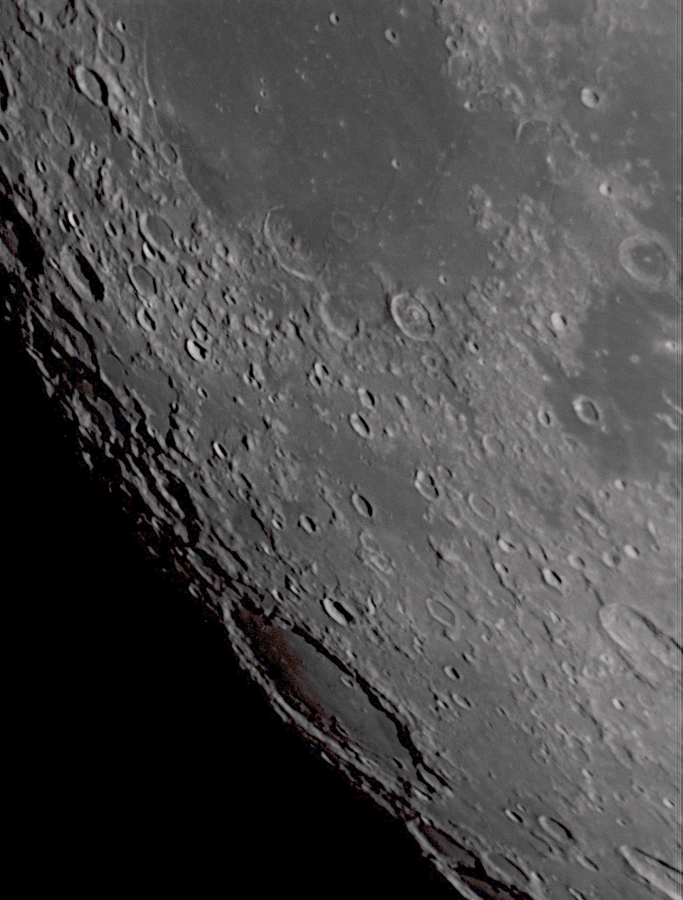 Another view looking toward the terminator, this time over the southern part of Mare Humorum. The prominent crater is named Schickard and is referred to as a 'walled plain', because it was at least partially flooded by lava after its formation.