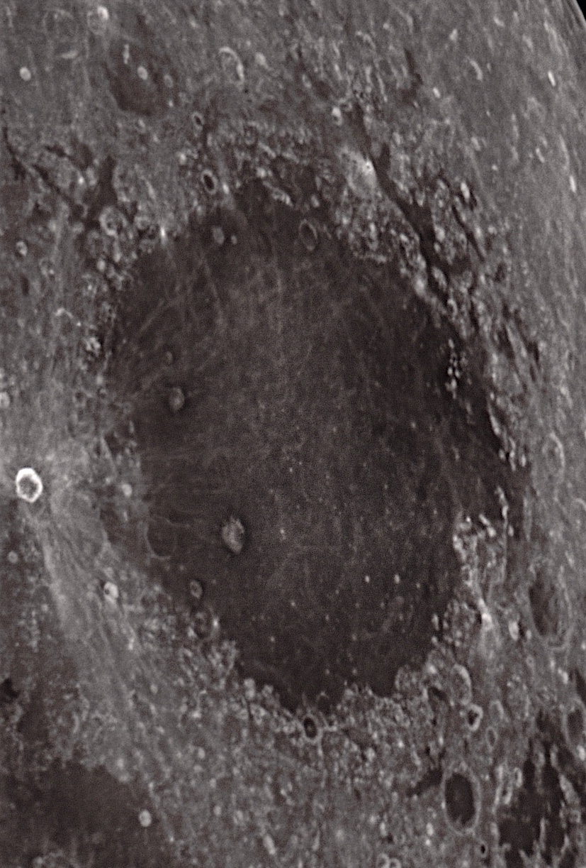 Mare Crisium (sea of Crises) is surrounded by highlands. To the left is the young impact crater Proclus, with its debris streams/rays.