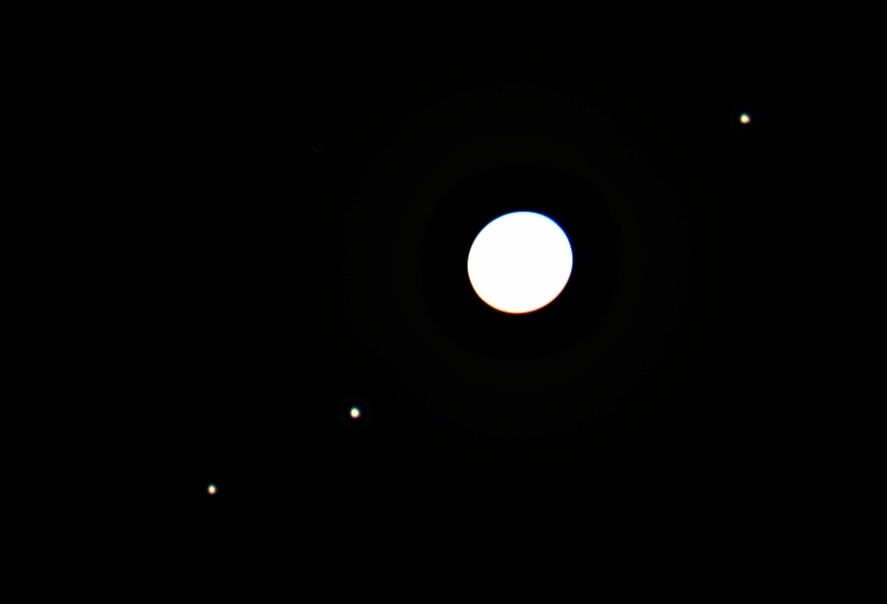 Jupiter itself is so bright that it must be overexposed in order to be able to pick out its major moons, three of which are laid out nicely in a line here.