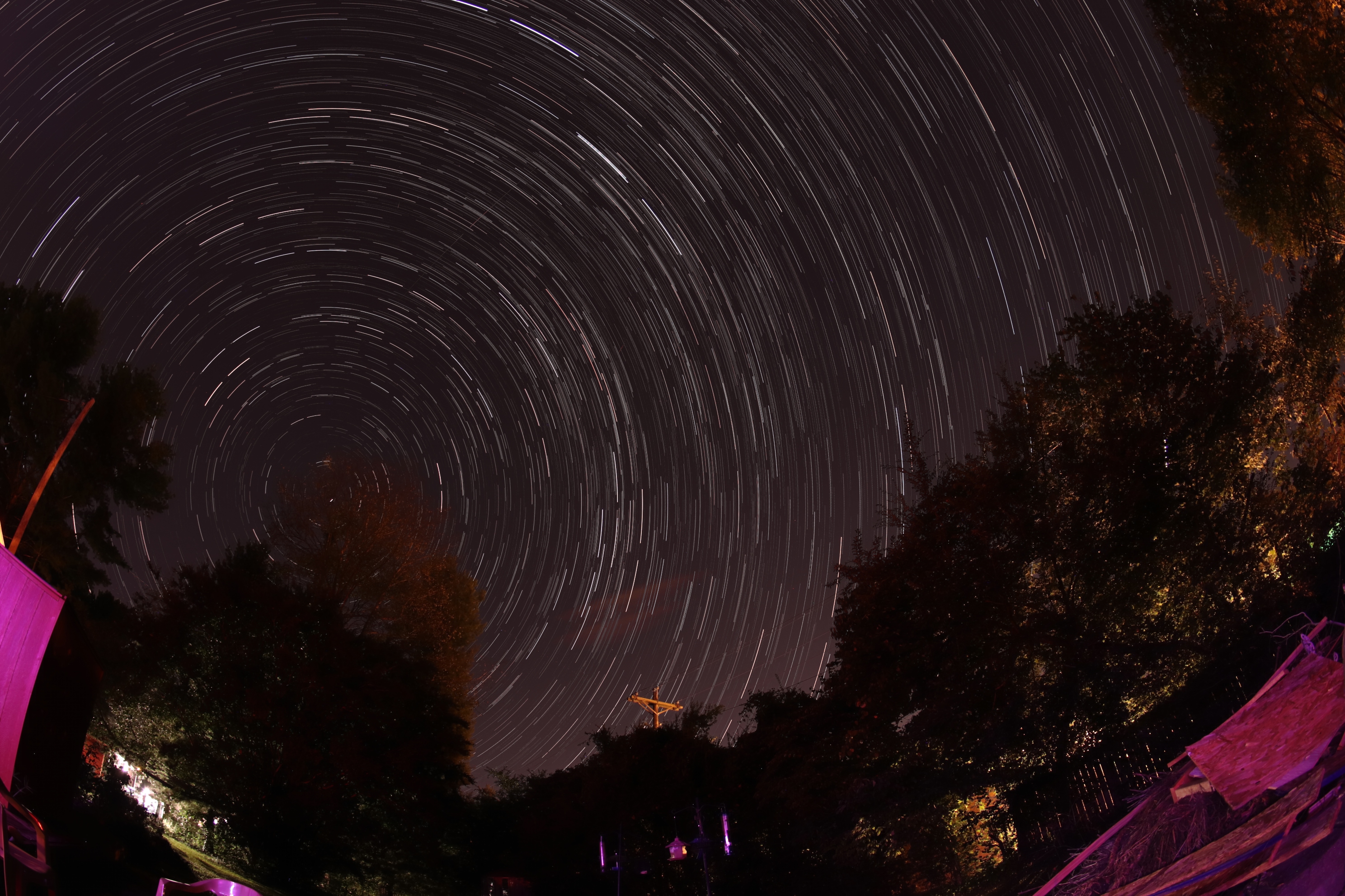 This is what you get when you use a fish-eye lens to take star trail images. So wide is the field of view that it is difficult not to include terrestrial light sources in the frame, which can make for some interesting effects.