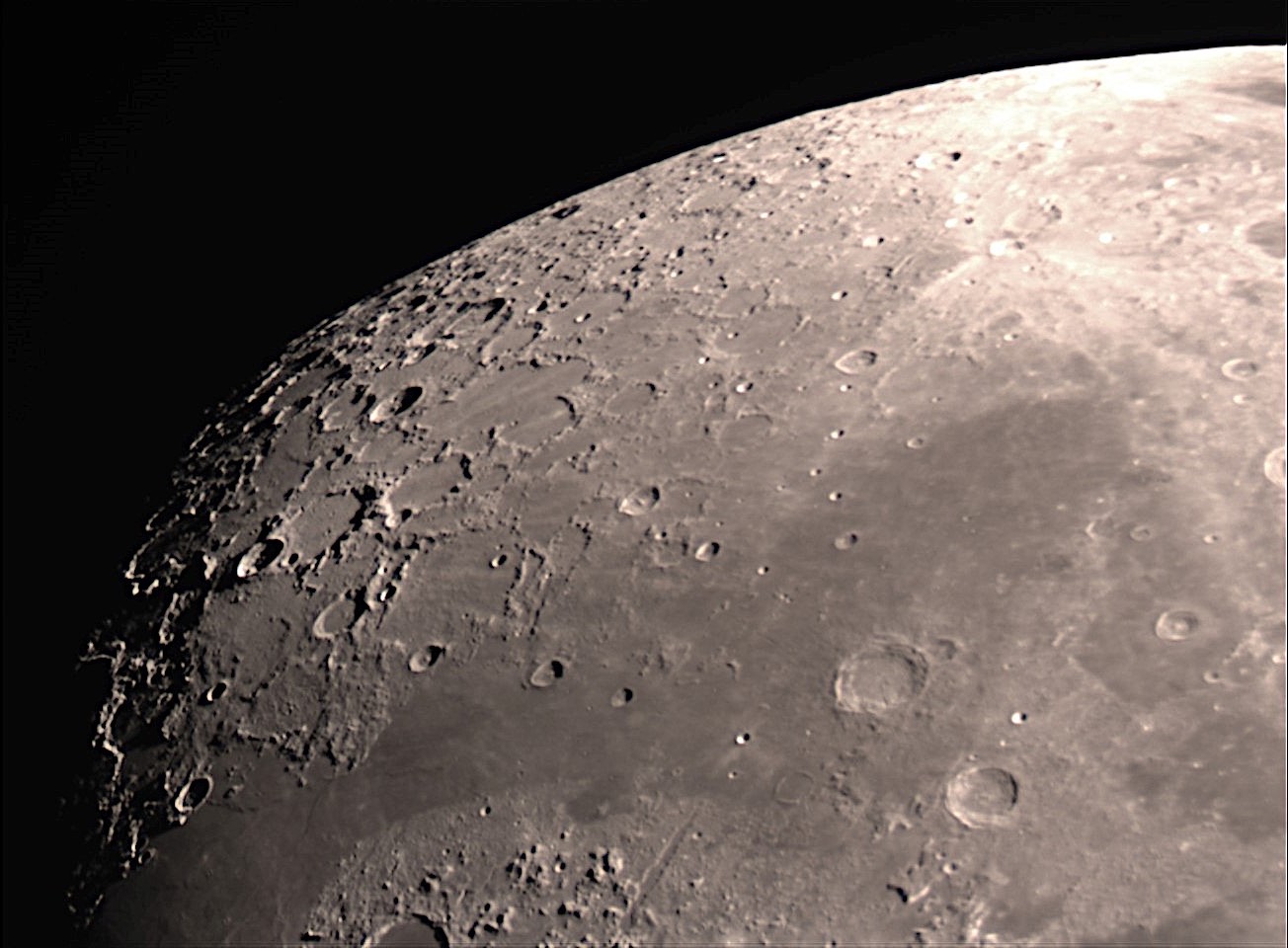 North pole area the Moon in a waxing gibbous phase. The two prominent craters to the lower right are Aristoteles and Eudoxus. Above and to the left of these is the Mare Frigoris (Sea of Cold).