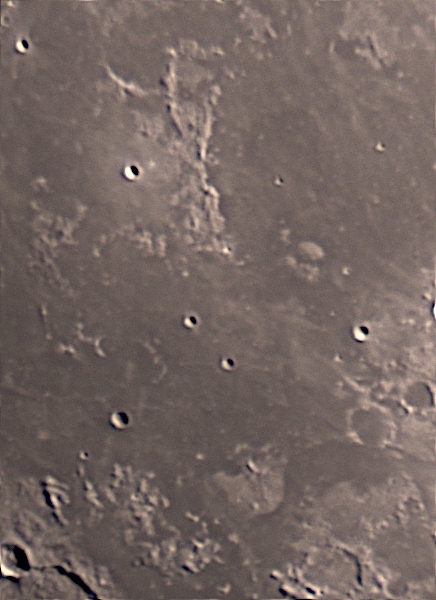 To the upper left of this image is Montes Riphaeus, an irregular range of lunar mountains lying between Mare Cognitum (Known Sea) and Oceanus Procellarum (Ocean of Storms). They are thought to be the remnants of an ancient wall that once bounded the massive crater that became Mare Cogitum when it was later flooded with lava.